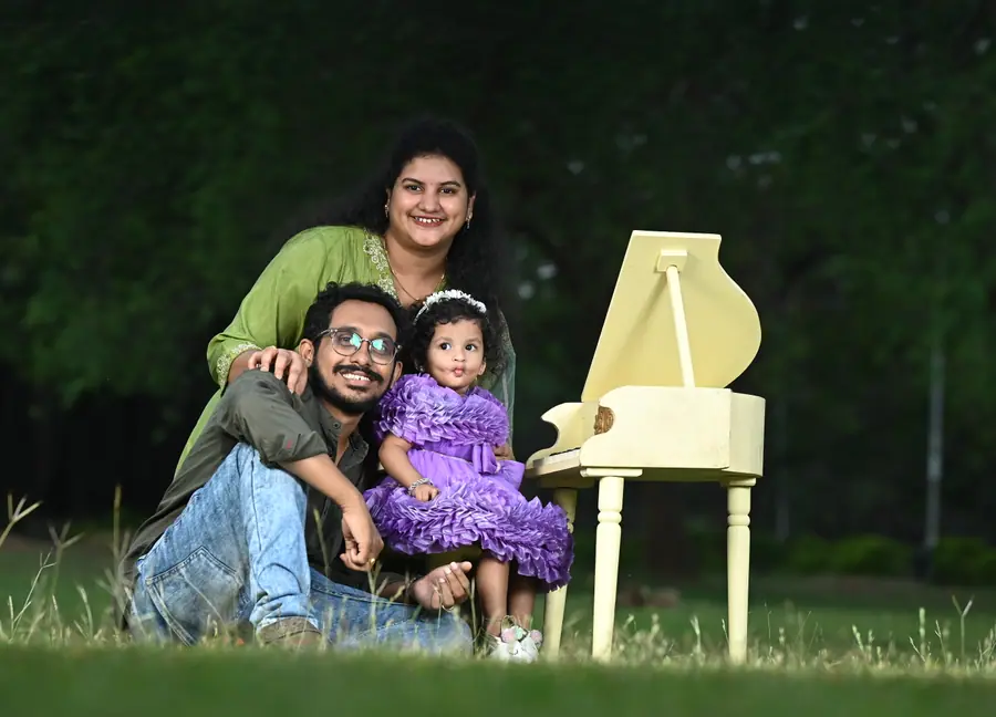 Family birthday portrait outdoors with a child in a purple dress