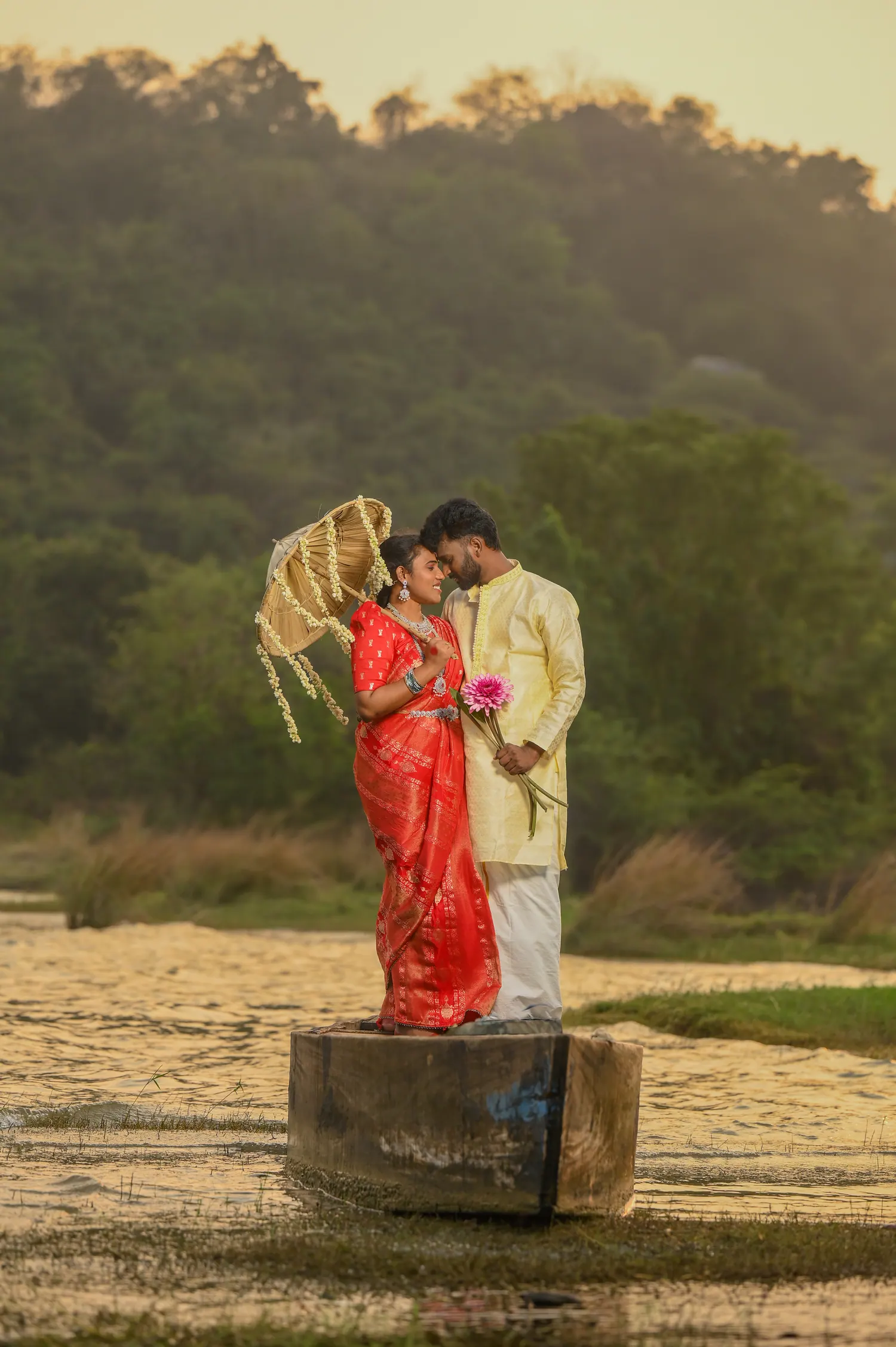 Pre-wedding couple portrait on a boat with a mountain backdrop