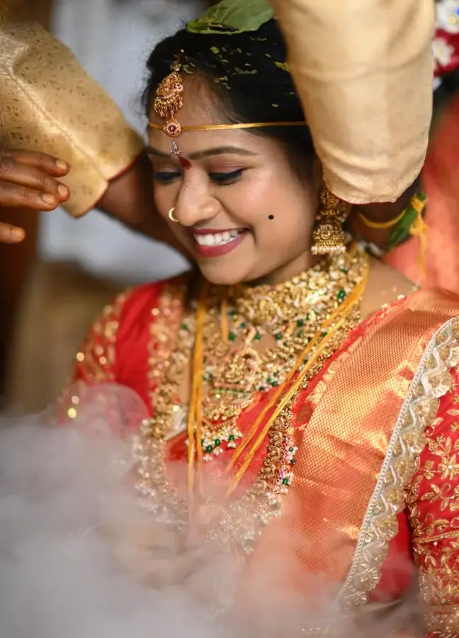 Close wedding ritual moment with bridal jewellery and warm ceremony light